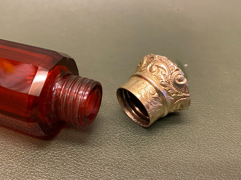 A Ruby glass DOUBLE-ENDED Scent Bottle with embossed gilt metal tops View IV