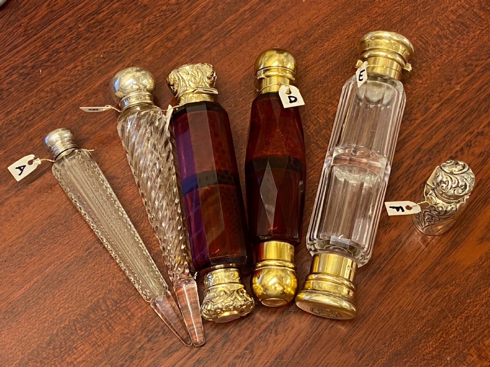 A Ruby glass DOUBLE-ENDED Scent Bottle with embossed gilt metal tops View V