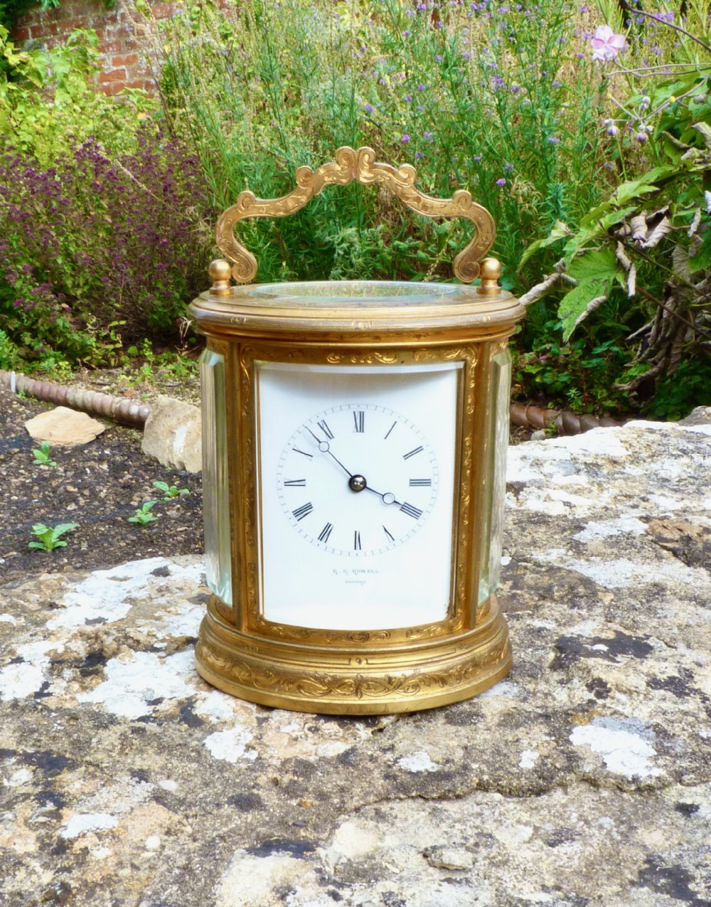 A SUPERB STRIKING OVAL CARRIAGE CLOCK