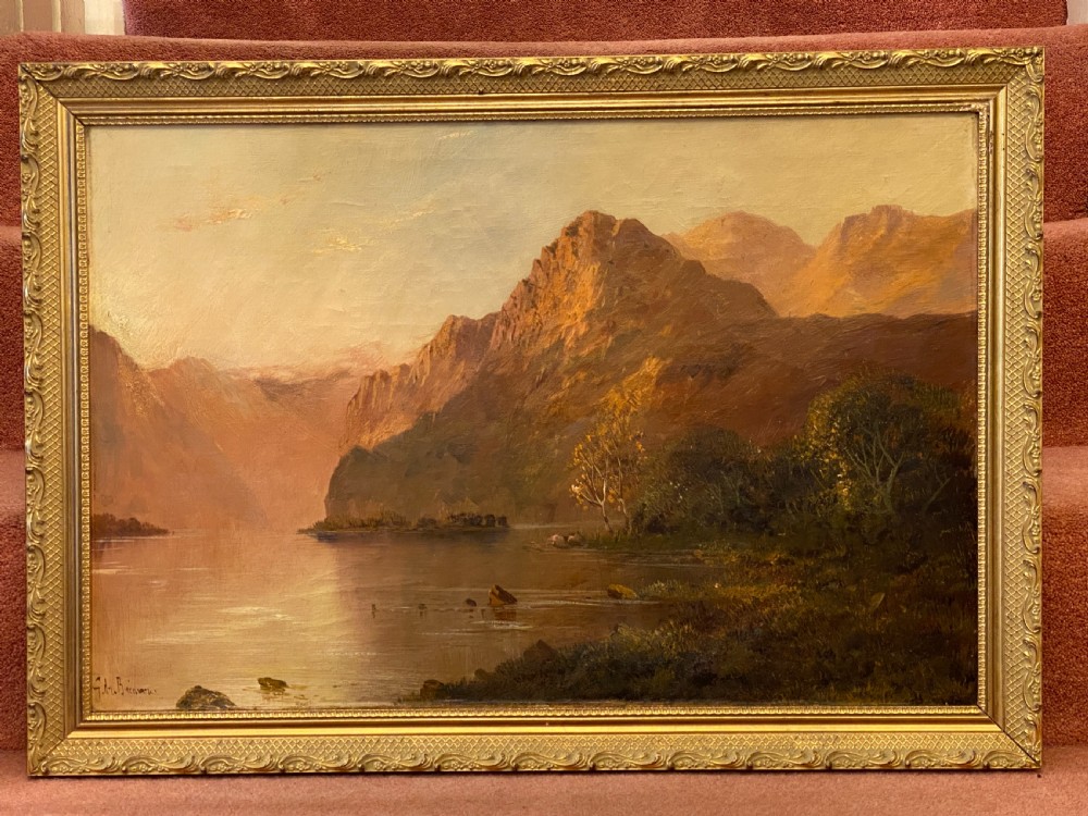 A Victorian oil painting on canvas by Gustave De Breanski depicting a mountainous lake view at sunrise in an ornate gilt frame. View II