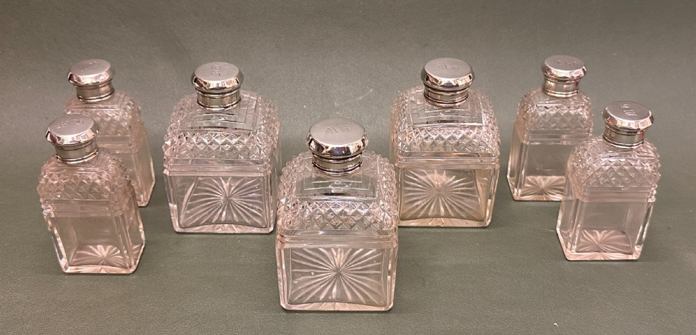 An open 19th-century kingwood dressing case with brass inlay, lined in blue velvet and fitted with silver-topped glass bottles, silver containers, and manicure tools. View VI
