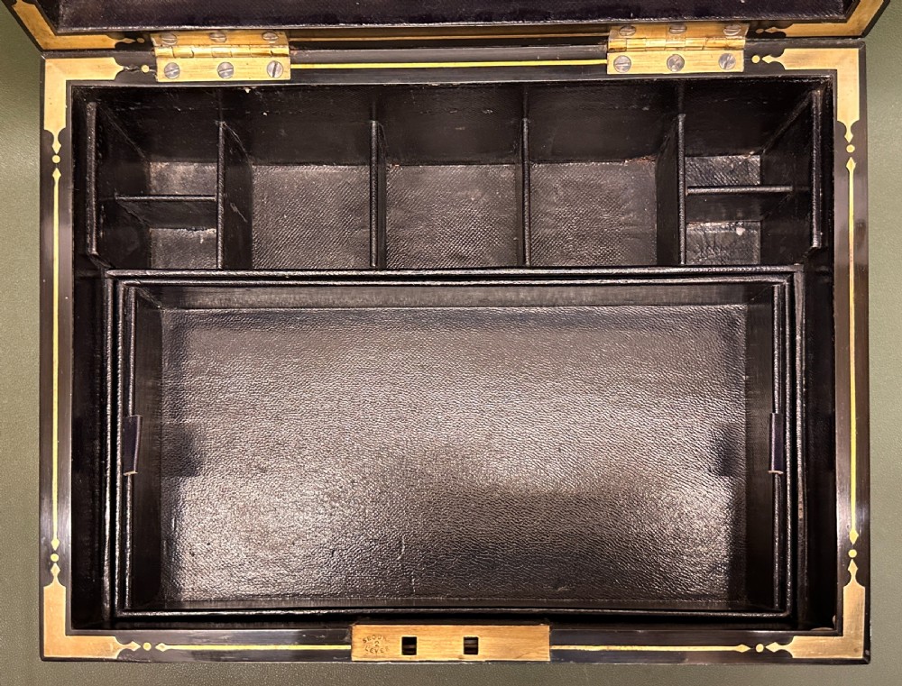 An open 19th-century kingwood dressing case with brass inlay, lined in blue velvet and fitted with silver-topped glass bottles, silver containers, and manicure tools. View XII