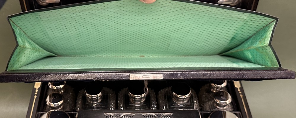 An open 19th-century kingwood dressing case with brass inlay, lined in blue velvet and fitted with silver-topped glass bottles, silver containers, and manicure tools. View XIV