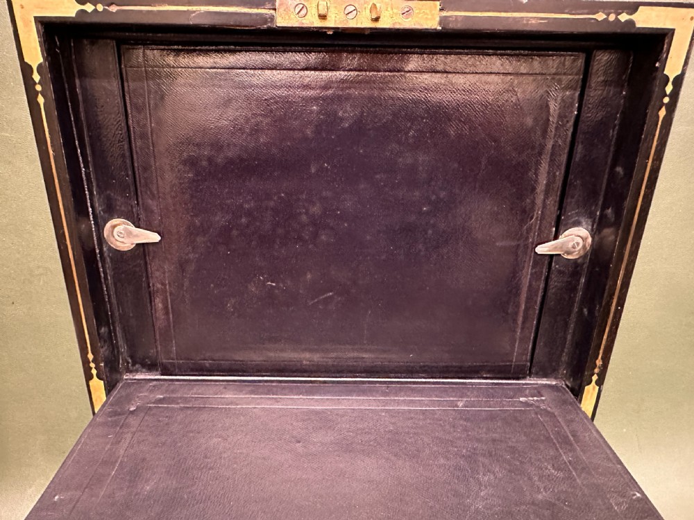 An open 19th-century kingwood dressing case with brass inlay, lined in blue velvet and fitted with silver-topped glass bottles, silver containers, and manicure tools. View XV