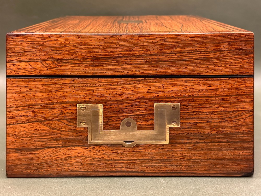 An open 19th-century kingwood dressing case with brass inlay, lined in blue velvet and fitted with silver-topped glass bottles, silver containers, and manicure tools. View XXIII