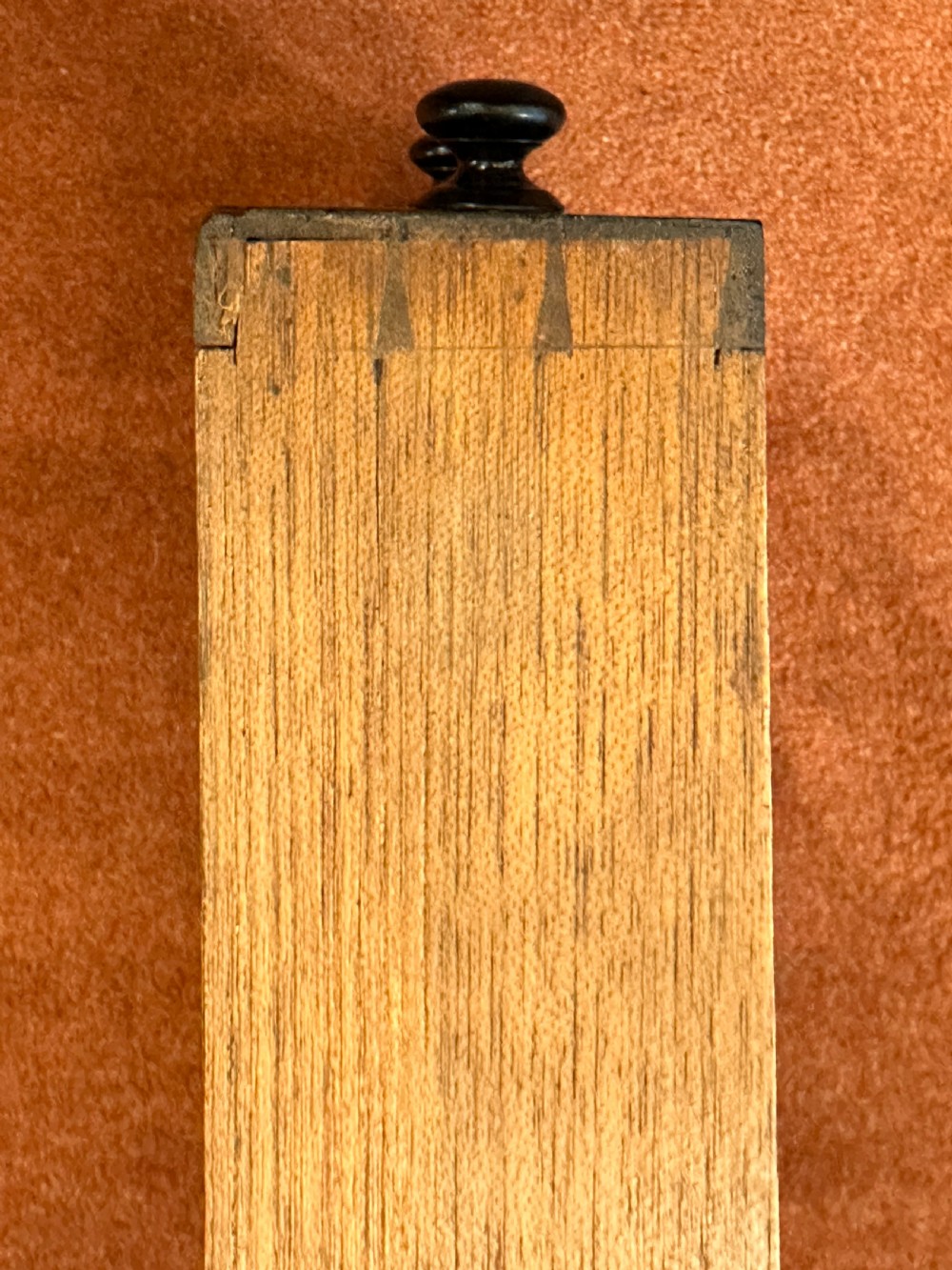 A 19th-century mahogany music Canterbury featuring four divided compartments, turned corner posts with finials, a single lower drawer with wooden knobs, and turned legs on brass castors. View VIII