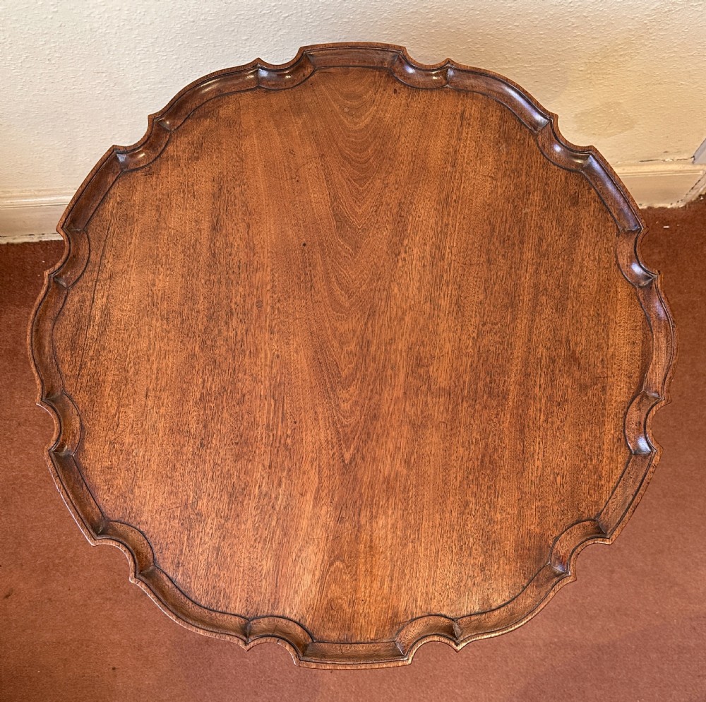 A mid-19th century mahogany occasional table with a scalloped piecrust rim, spiral-turned central column, and tripod cabriole legs. View VII