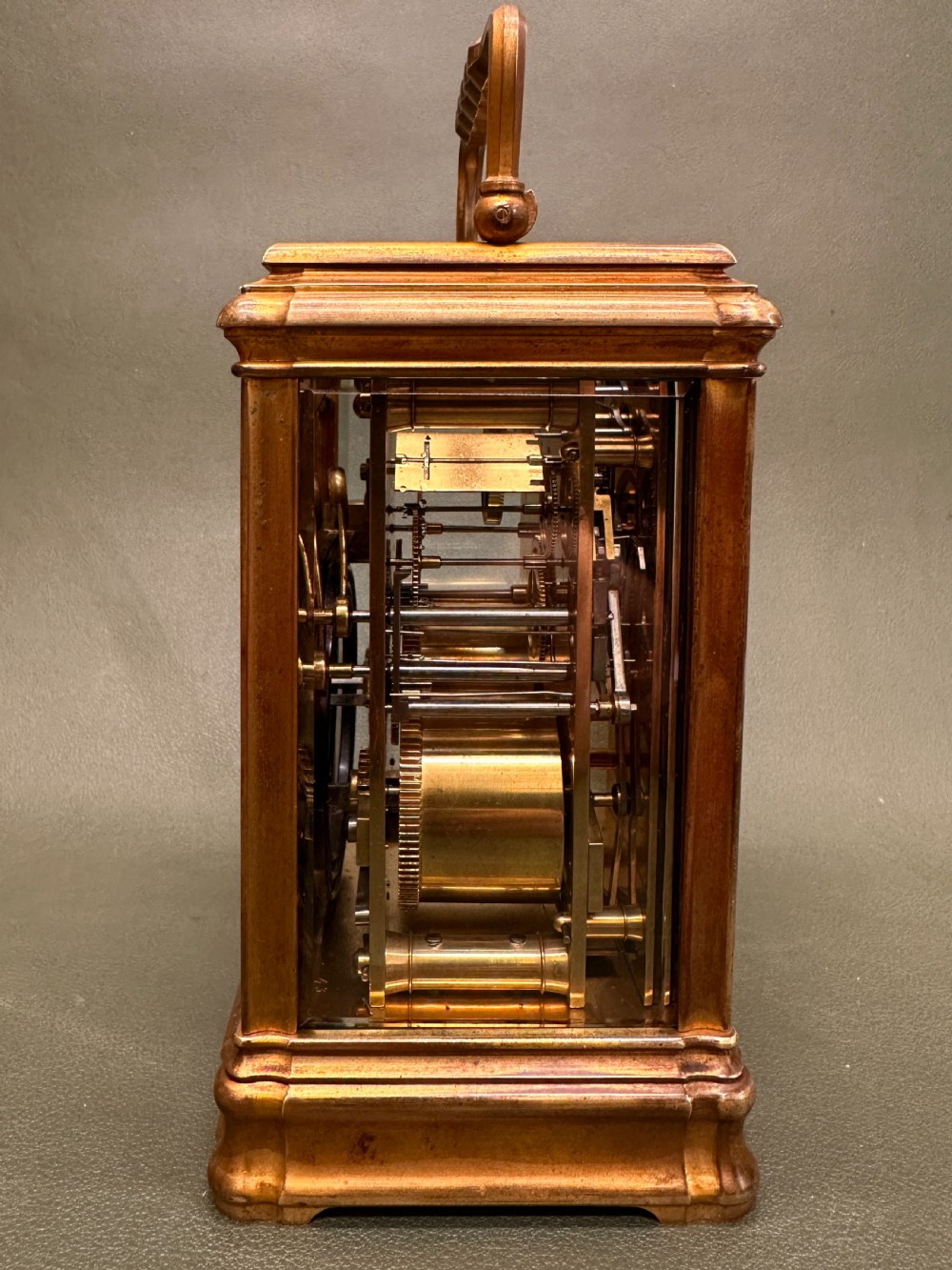 A Victorian gilt brass carriage clock with a white enamel dial next to its leather travelling box and double-ended winding key. View XI