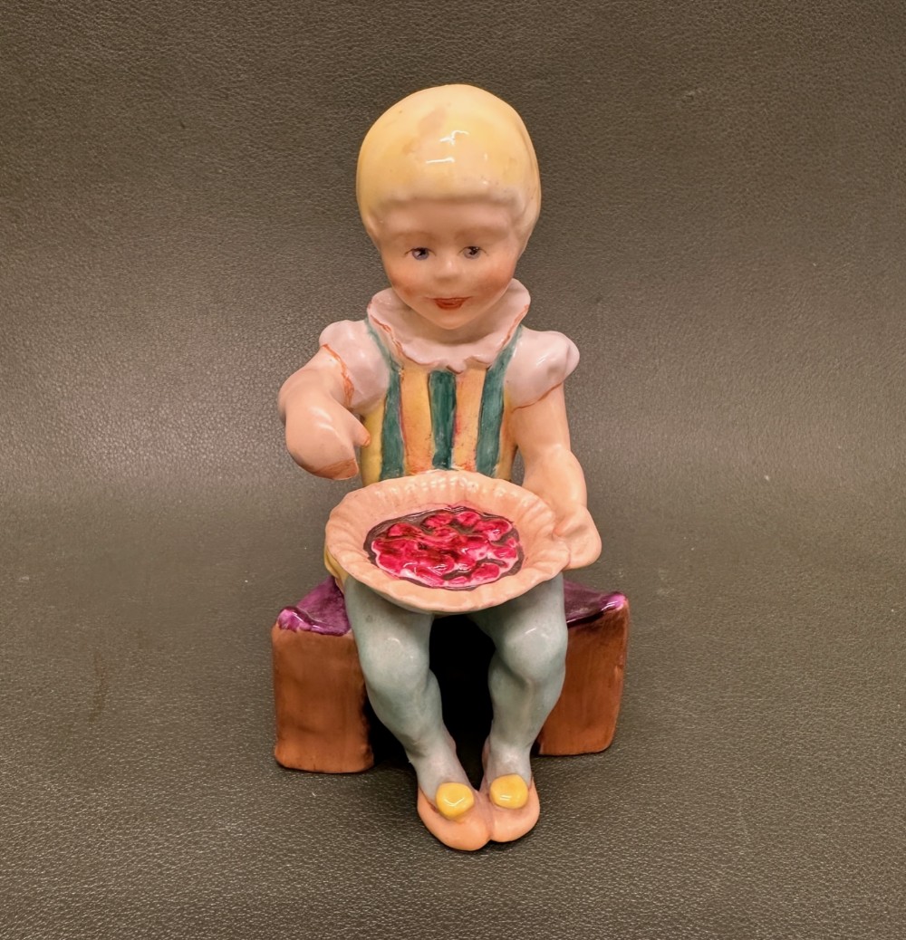 A hand-painted Royal Worcester porcelain figurine depicting a seated boy holding a pie, titled Little Jack Horner.