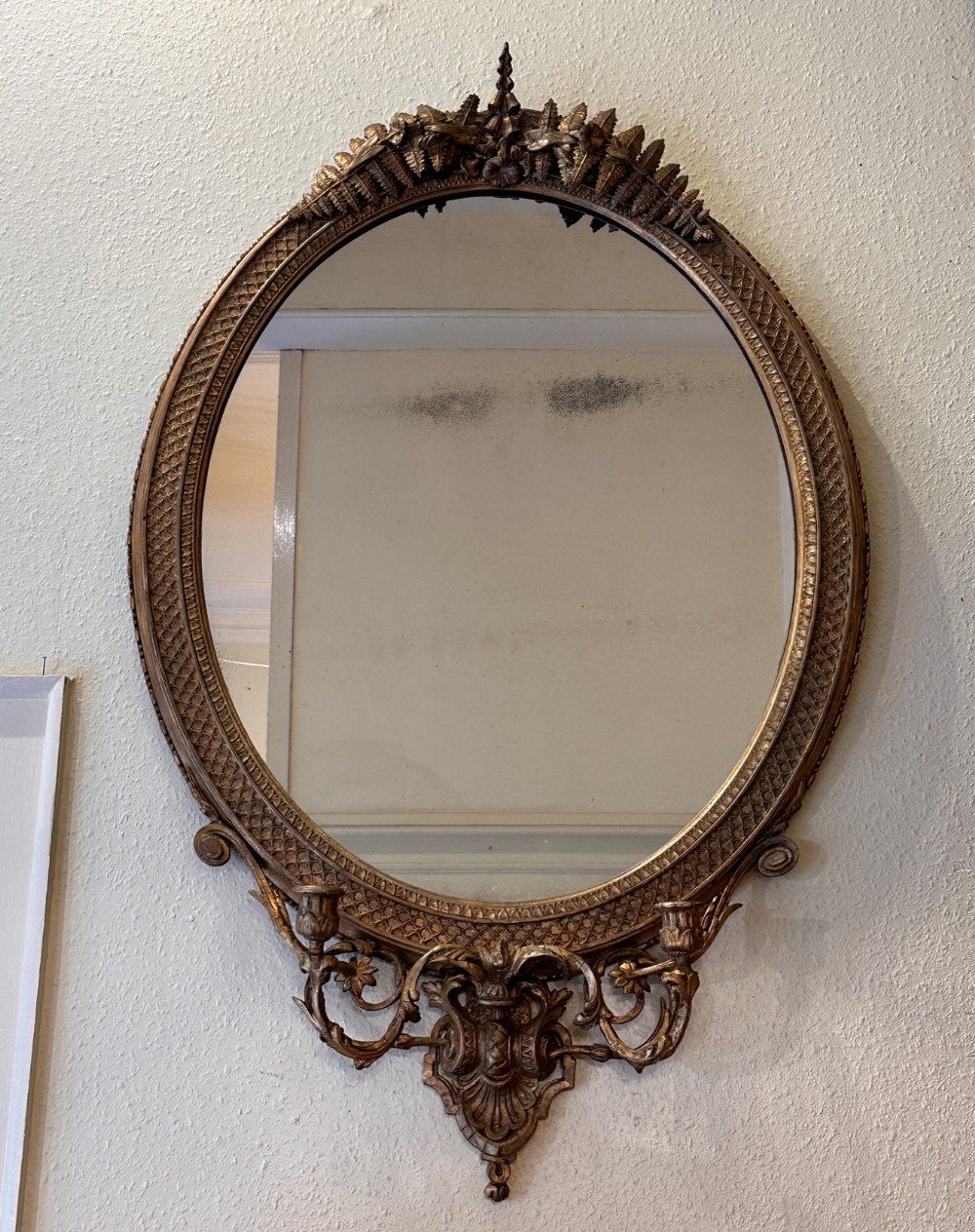 Late 18th / Early 19th century carved gilt framed oval mirror