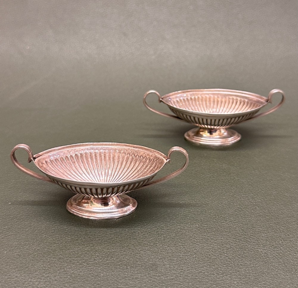 A PAIR of miniature Victorian hallmarked silver two-handled oval SALTS, 1891