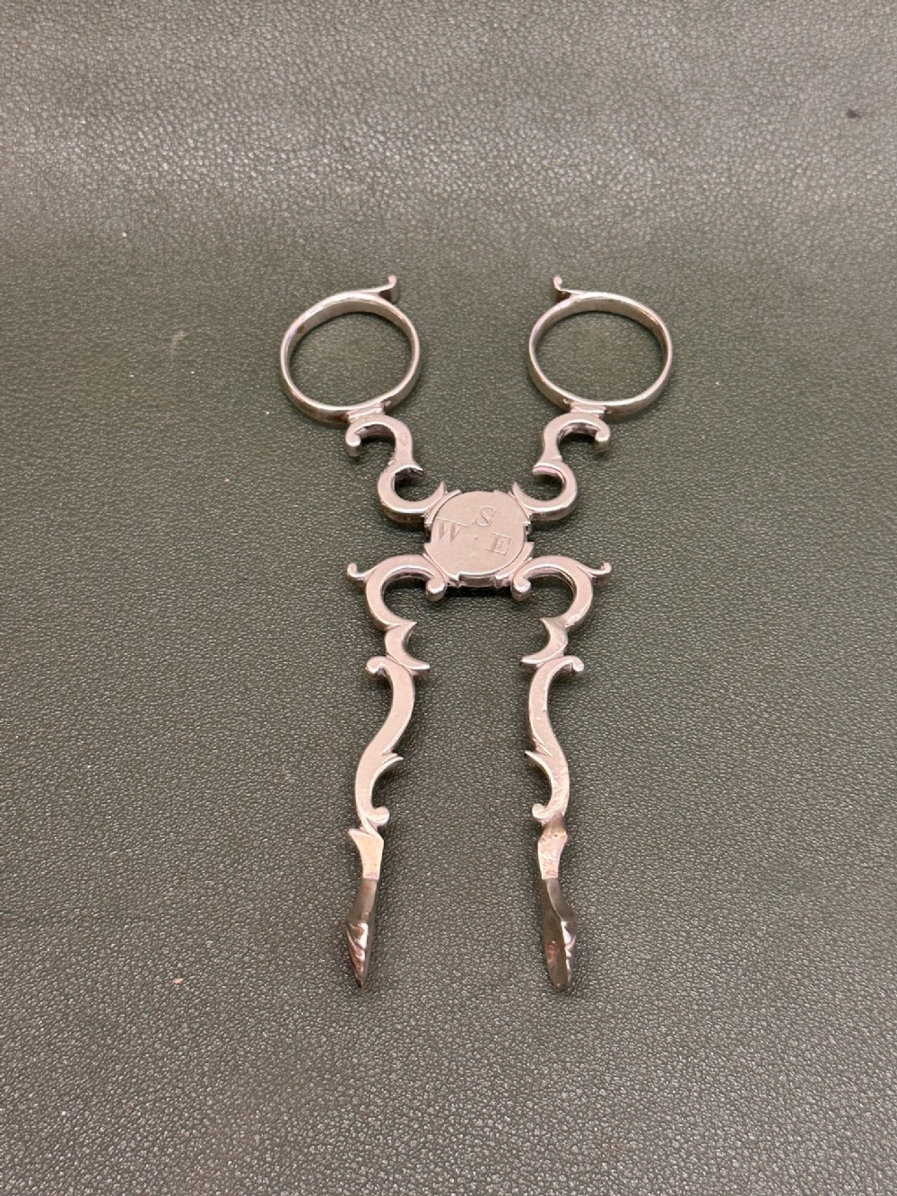 Fine pair of 18th century hallmarked silver sugar nips in cast rococo form
