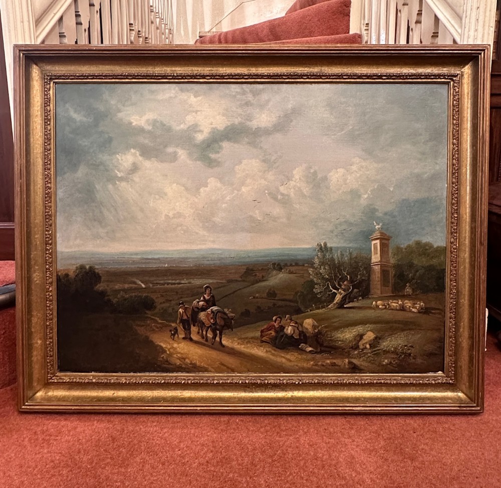 An eighteenth-century framed oil painting depicting figures, animals, and a stone monument set within a rural landscape under a cloudy sky.