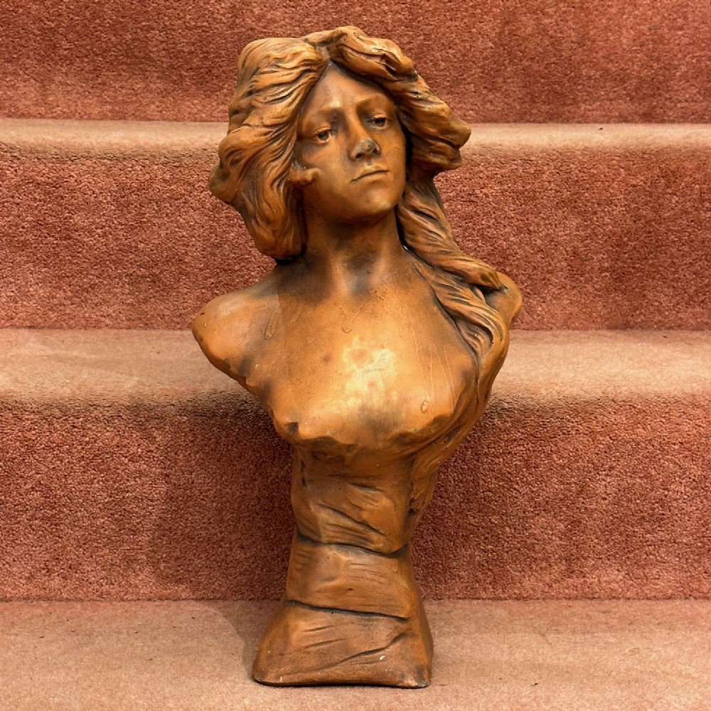 An Art Nouveau Terracotta Bust of a semi-clad young lady