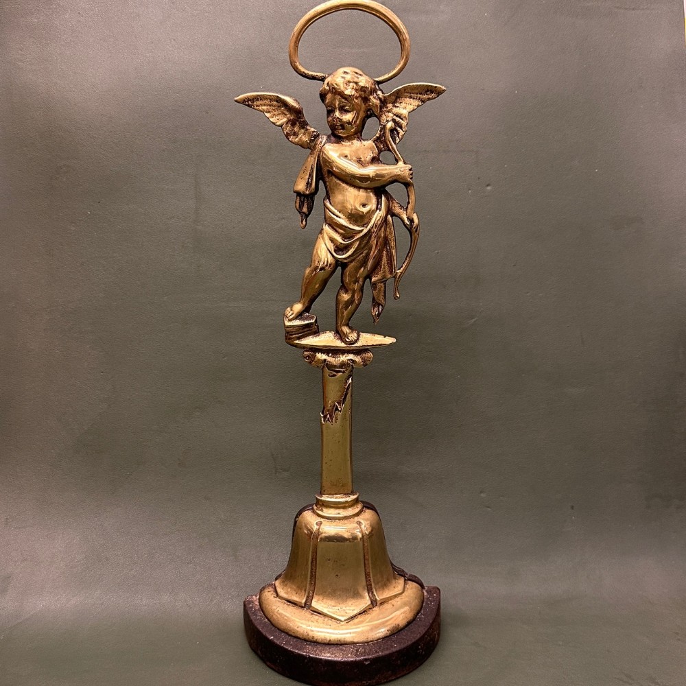 19th century brass door-stop in the form of a semi-clad winged cherub