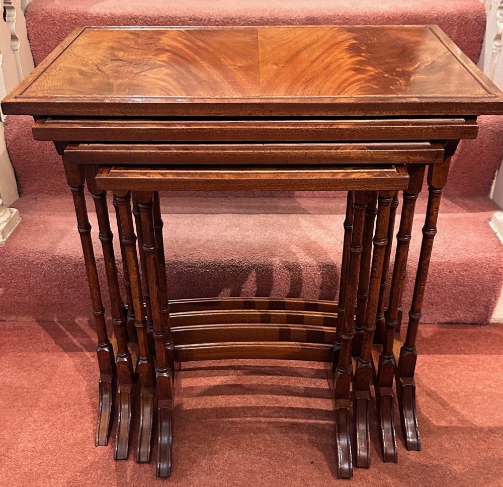 Nest of FOUR walnut veneered occasional tables