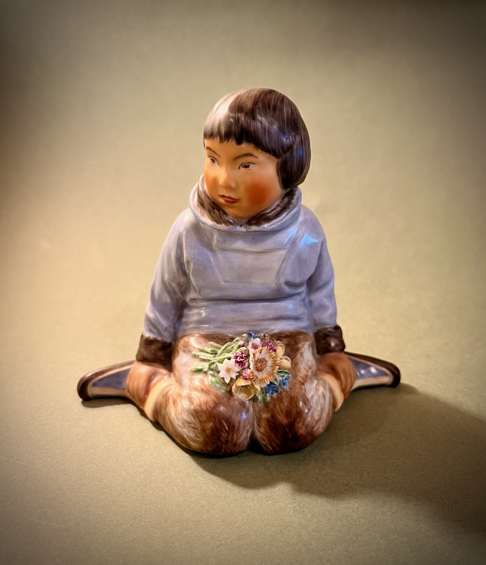 A set of ten hand-painted Royal Copenhagen porcelain figurines depicting seated children wearing traditional Danish regional costumes and floral garlands. View VI