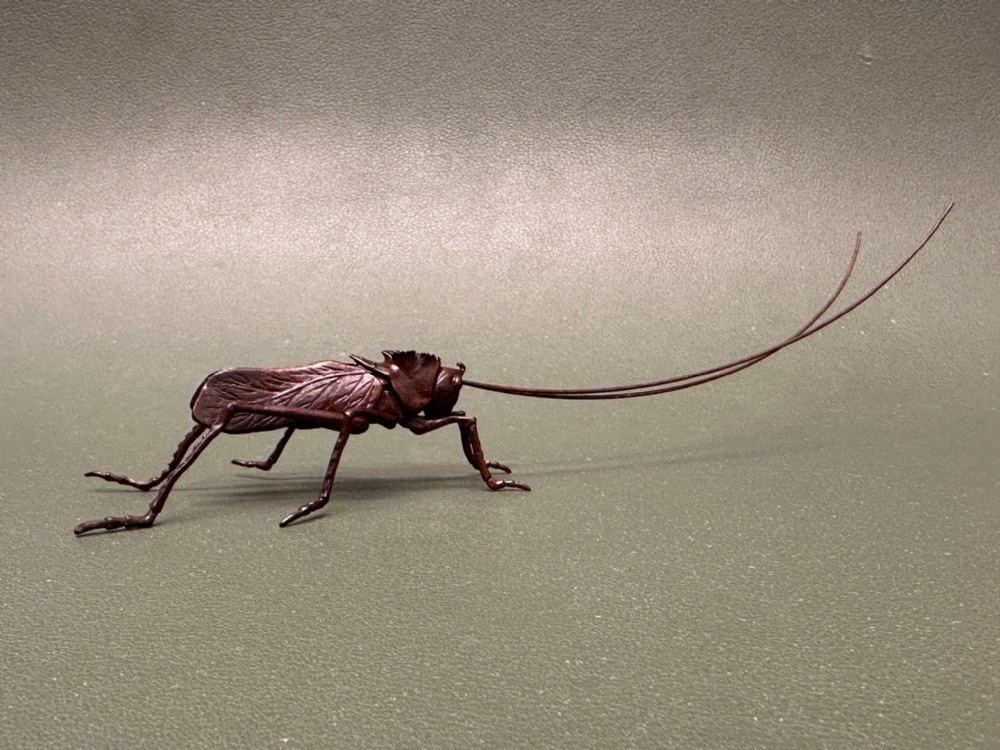 A Japanese bronze Jizai style okimono of a Grasshopper (Meiji period 1868-1912)
