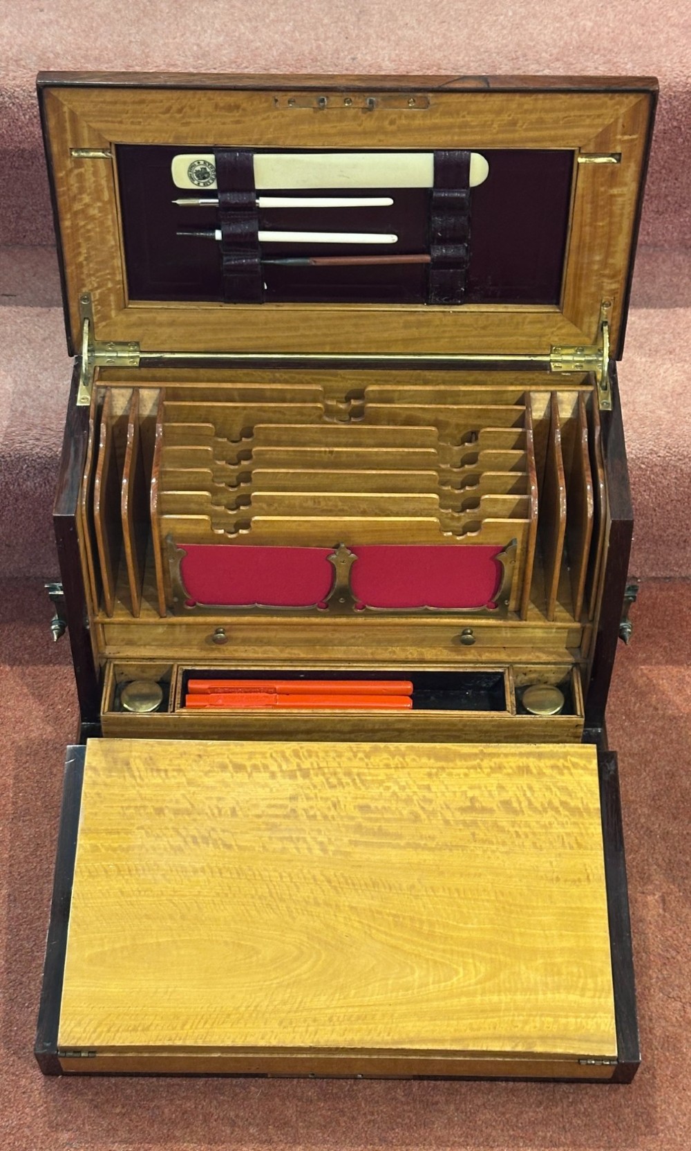 A rectangular dark rosewood writing box featuring central satinwood marquetry of an urn with foliate scrolls and a central brass keyhole escutcheon. View II