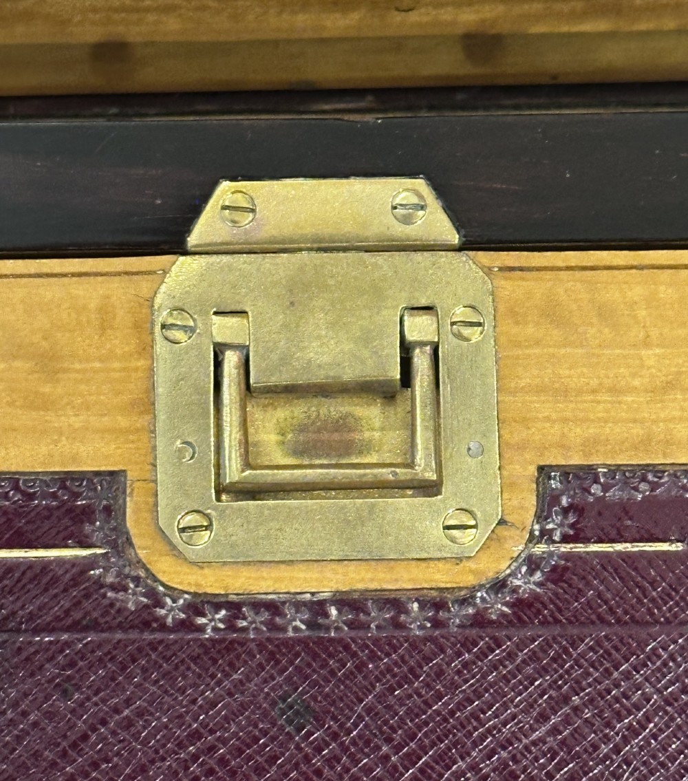 A rectangular dark rosewood writing box featuring central satinwood marquetry of an urn with foliate scrolls and a central brass keyhole escutcheon. View IV