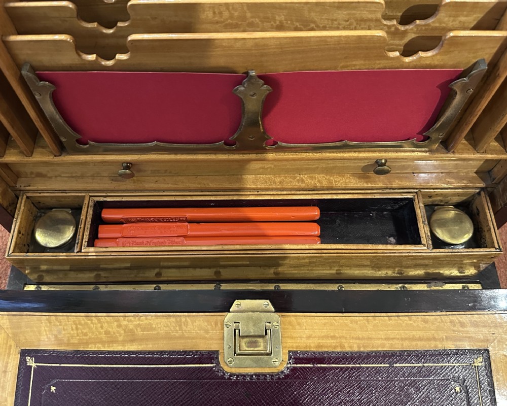 A rectangular dark rosewood writing box featuring central satinwood marquetry of an urn with foliate scrolls and a central brass keyhole escutcheon. View VII