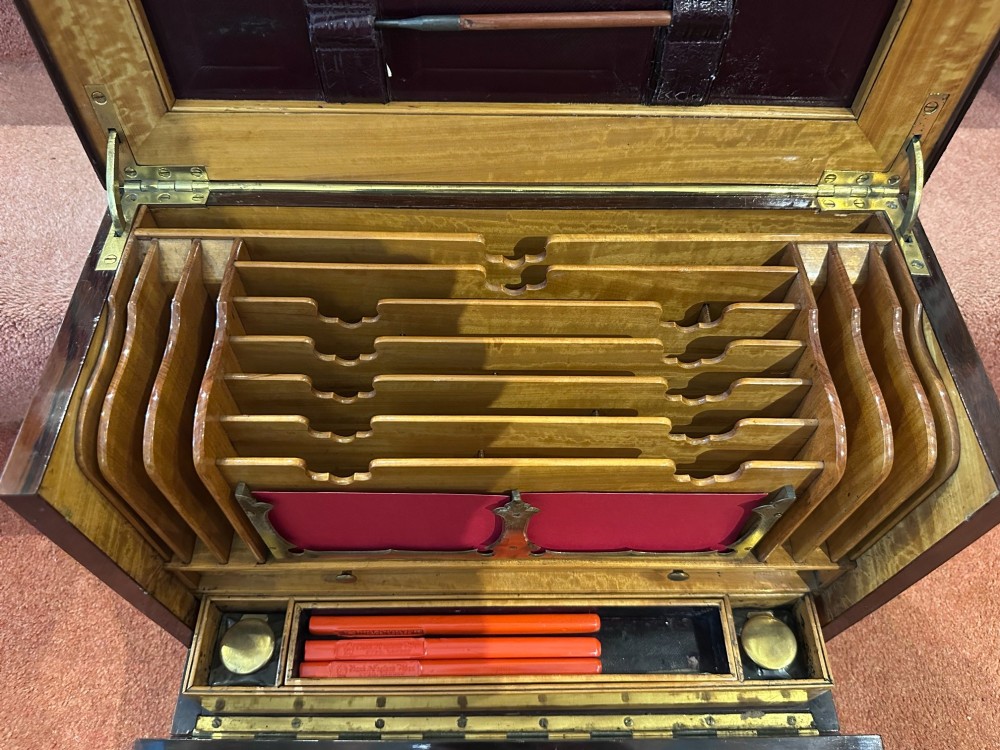 A rectangular dark rosewood writing box featuring central satinwood marquetry of an urn with foliate scrolls and a central brass keyhole escutcheon. View VIII