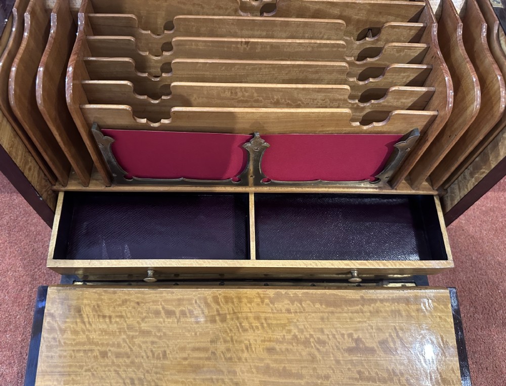 A rectangular dark rosewood writing box featuring central satinwood marquetry of an urn with foliate scrolls and a central brass keyhole escutcheon. View X