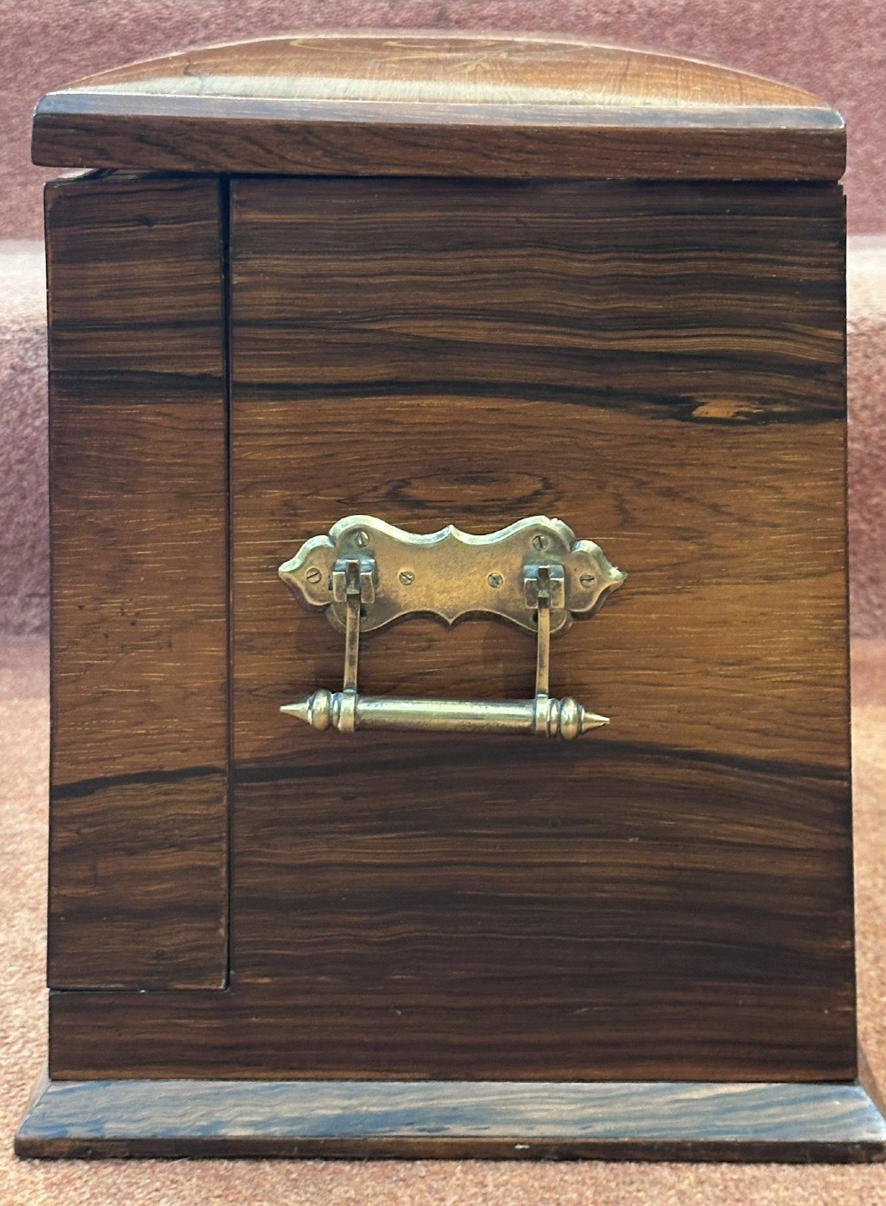 A rectangular dark rosewood writing box featuring central satinwood marquetry of an urn with foliate scrolls and a central brass keyhole escutcheon. View XIII