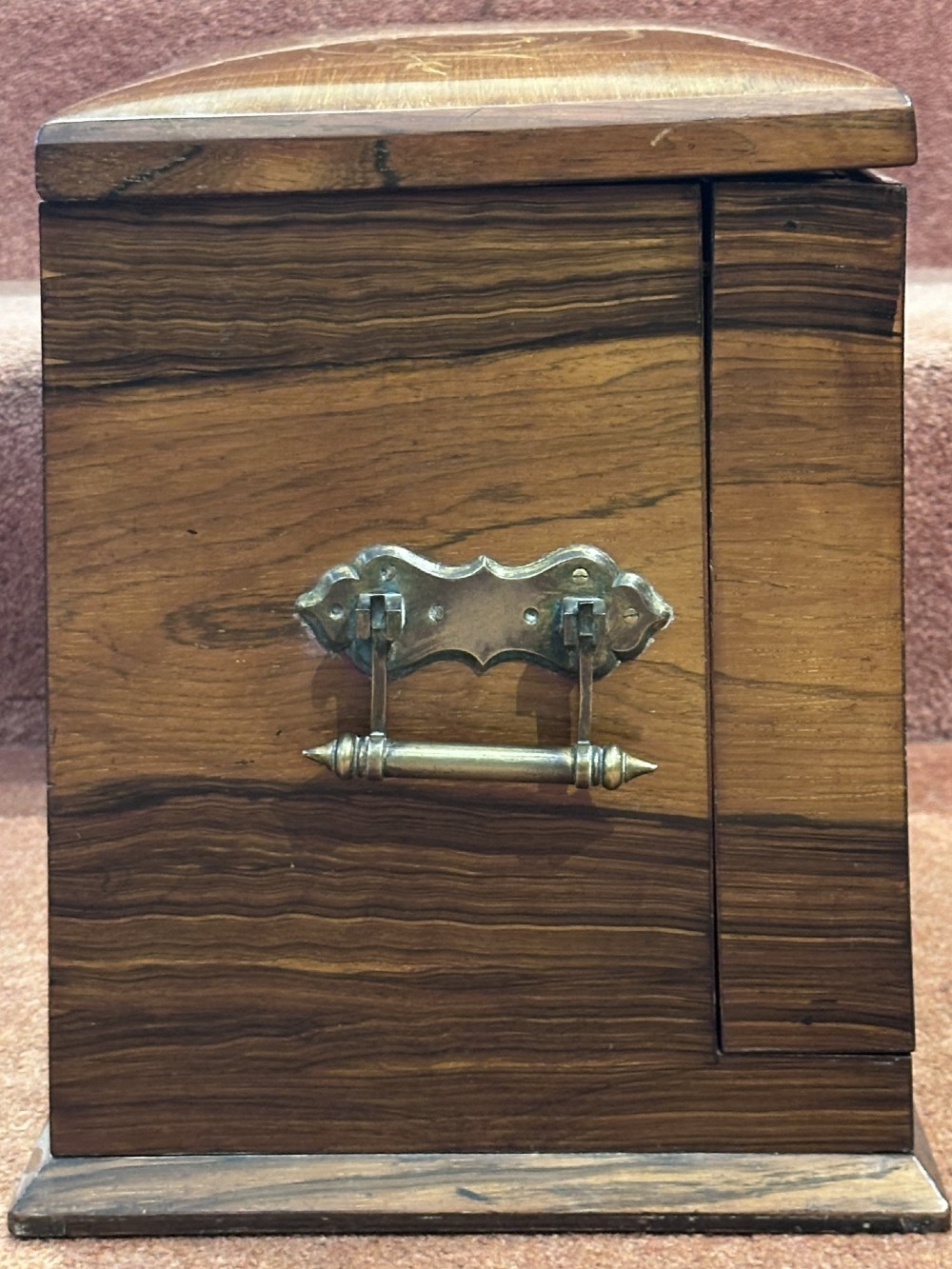 A rectangular dark rosewood writing box featuring central satinwood marquetry of an urn with foliate scrolls and a central brass keyhole escutcheon. View XV