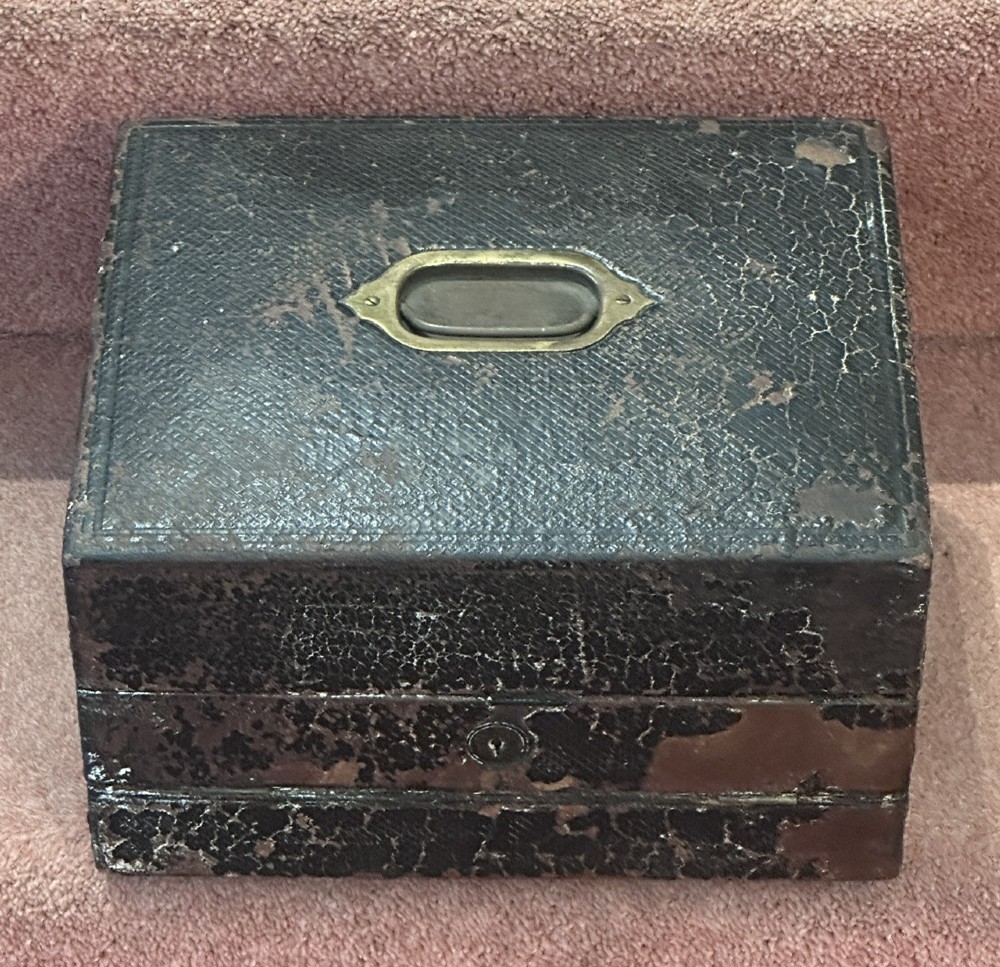 An open Victorian leather-bound writing box featuring internal letter slots, a pen tray, an inkwell compartment, and brass hardware. View II