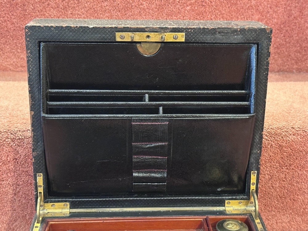 An open Victorian leather-bound writing box featuring internal letter slots, a pen tray, an inkwell compartment, and brass hardware. View VIII