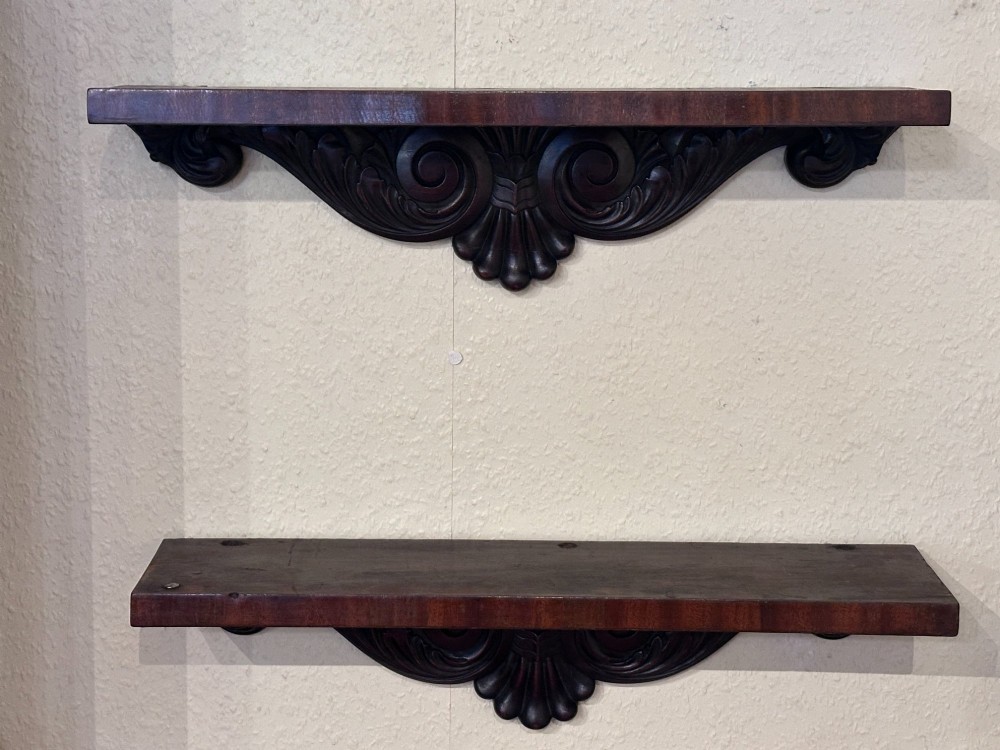 PAIR of Georgian carved mahogany hanging wall shelves