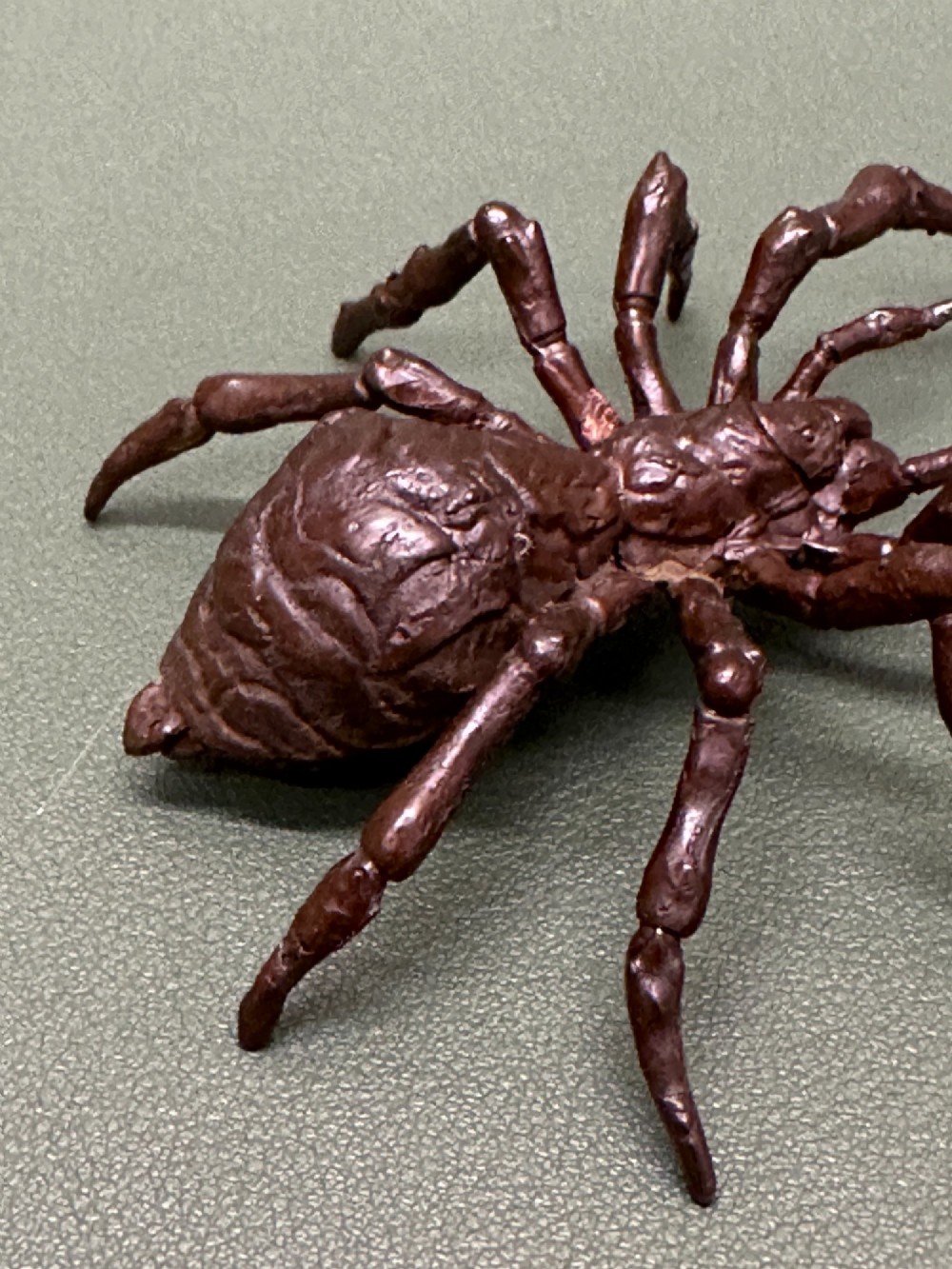 A detailed patinated dark brown bronze okimono sculpture modelled in the form of a tarantula spider. View X