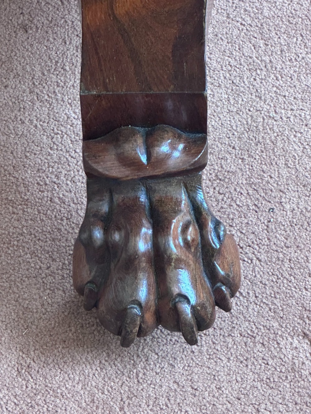 A circular William IV tilt-top rosewood centre table featuring symmetrical book-matched veneer and a central pedestal base with carved claw feet. View III