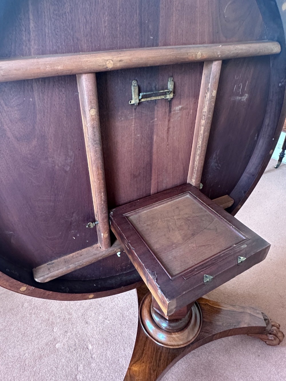 A circular William IV tilt-top rosewood centre table featuring symmetrical book-matched veneer and a central pedestal base with carved claw feet. View IV