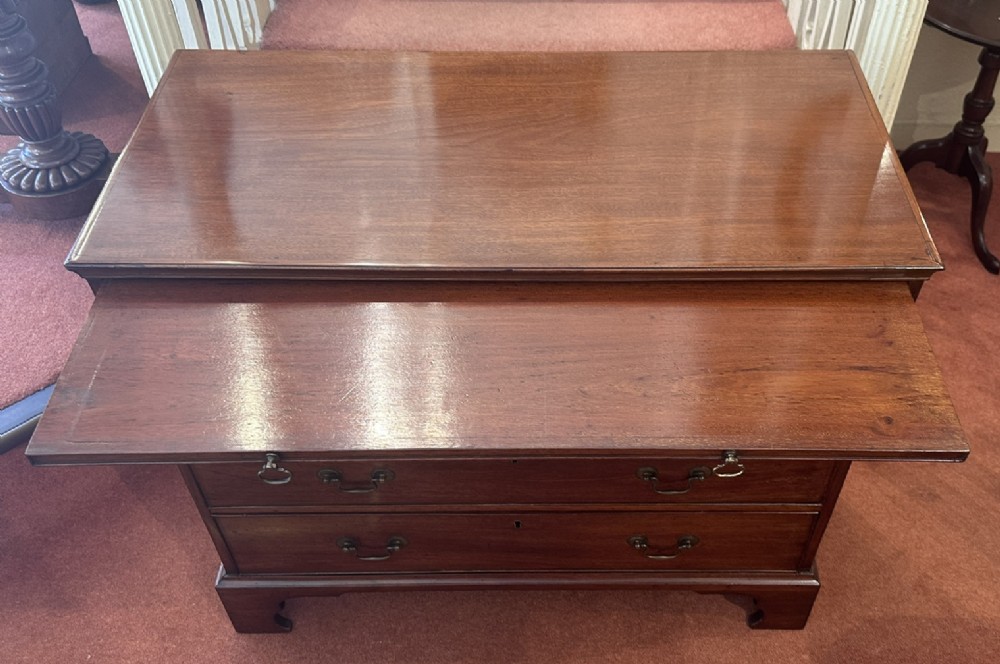An 18th-century George III mahogany bachelors chest featuring four graduated drawers, brass swan-neck handles, a pull-out brushing slide, and bracket feet. View VI