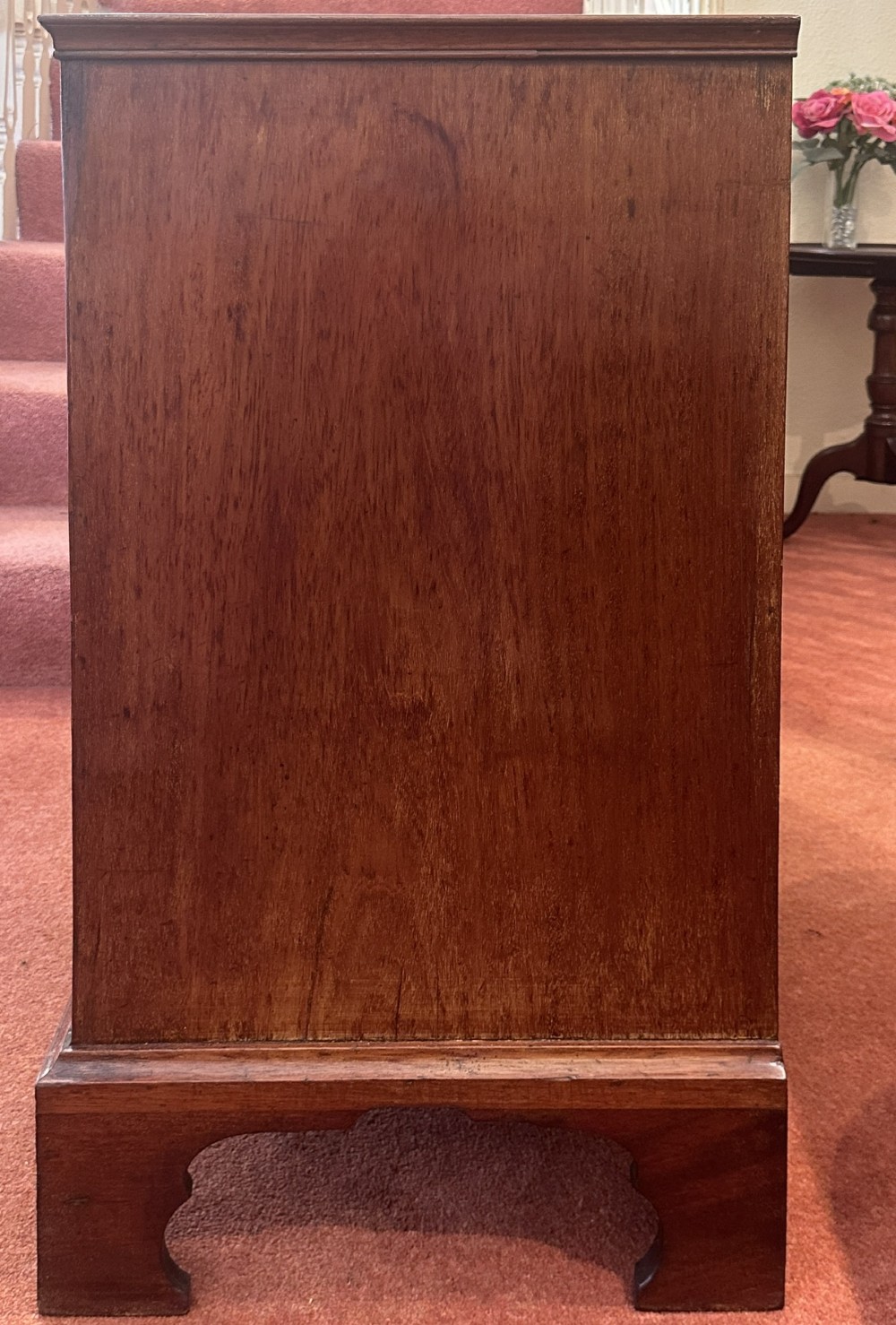 An 18th-century George III mahogany bachelors chest featuring four graduated drawers, brass swan-neck handles, a pull-out brushing slide, and bracket feet. View IX