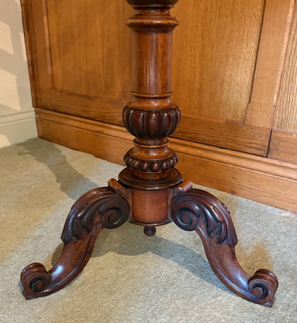An antique mahogany duet music stand with a double slatted desk, brass candle sconces, a turned central column, and carved tripod scroll legs. View II