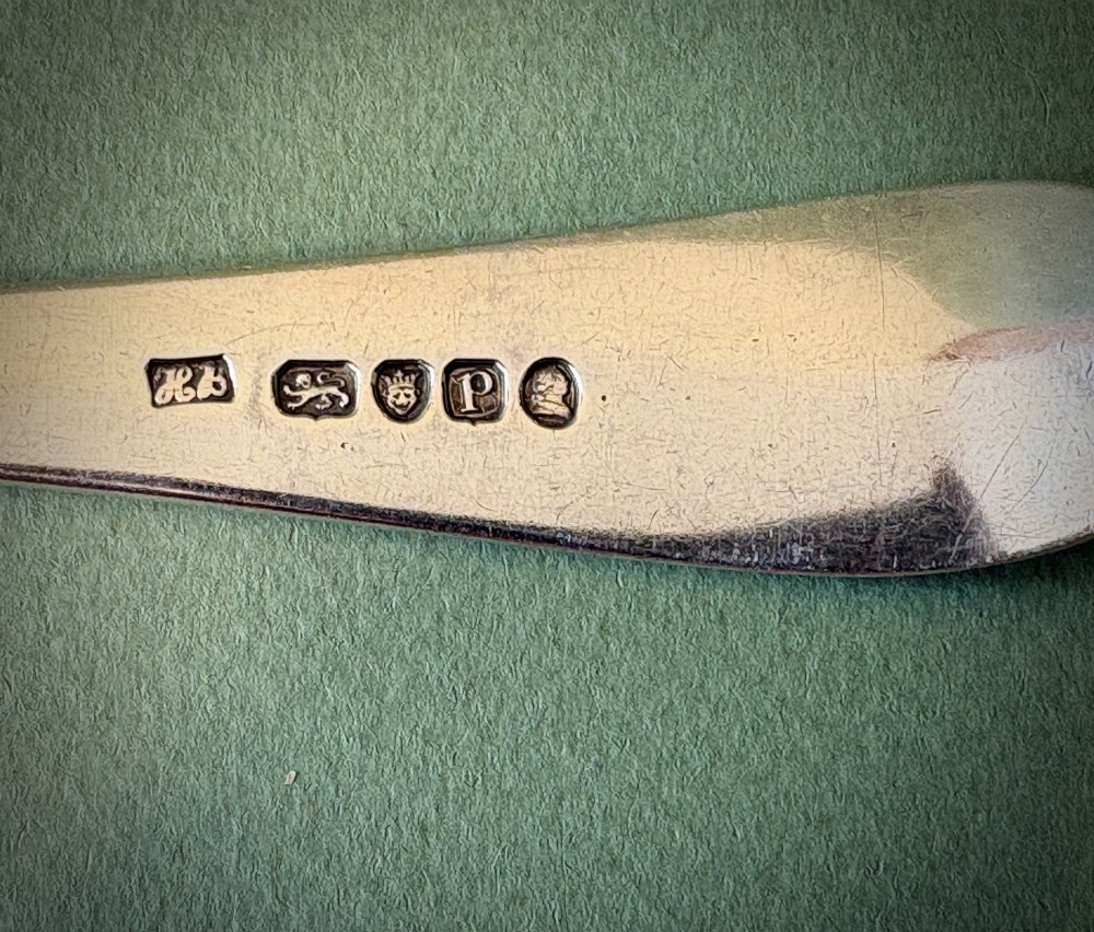 A pair of 18th-century sterling silver basting spoons featuring elongated handles with engraved monograms and oval bowls. View III