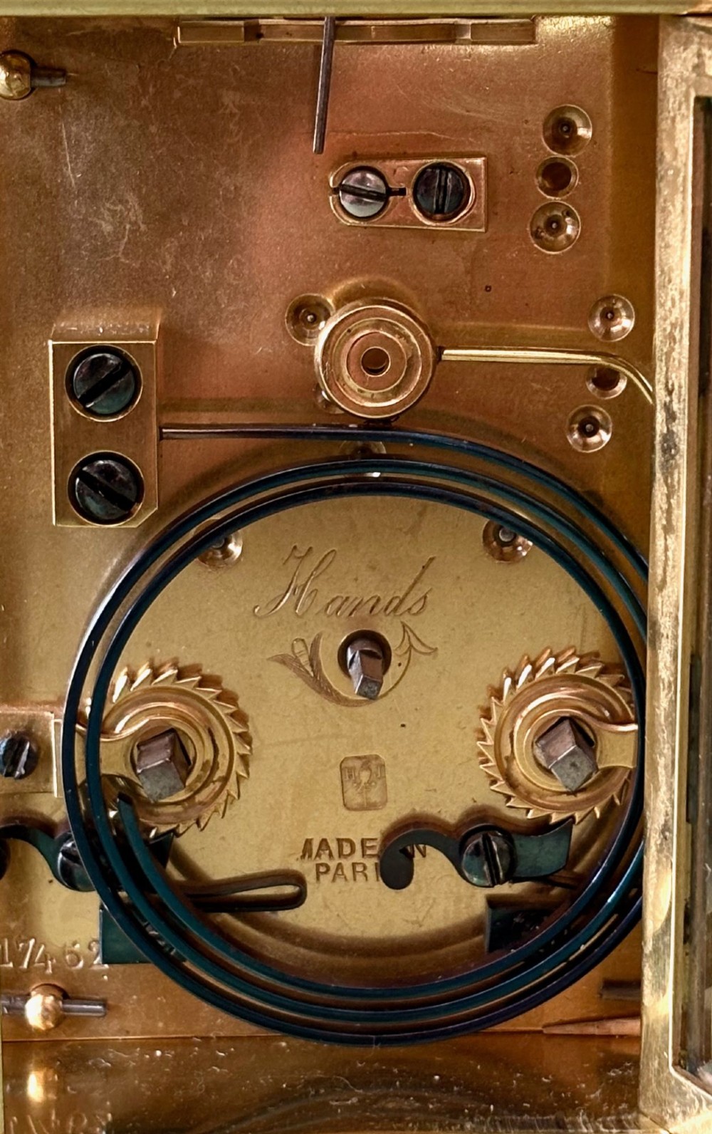 A nineteenth-century French carriage clock featuring a gilt brass case, glass side panels, a hinged top handle, and a white enamel dial with black Roman numerals. View IV