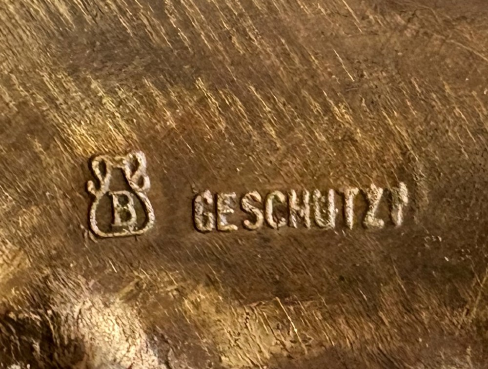 An Austrian cold-painted bronze figure group depicting a draped Orientalist figure standing beside a female figure on a patterned carpet base. View VI