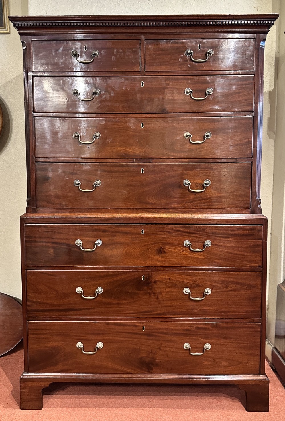 A tall George III mahogany chest-on-chest featuring two upper short drawers over three long drawers, resting on a base section with three further long drawers and bracket feet.