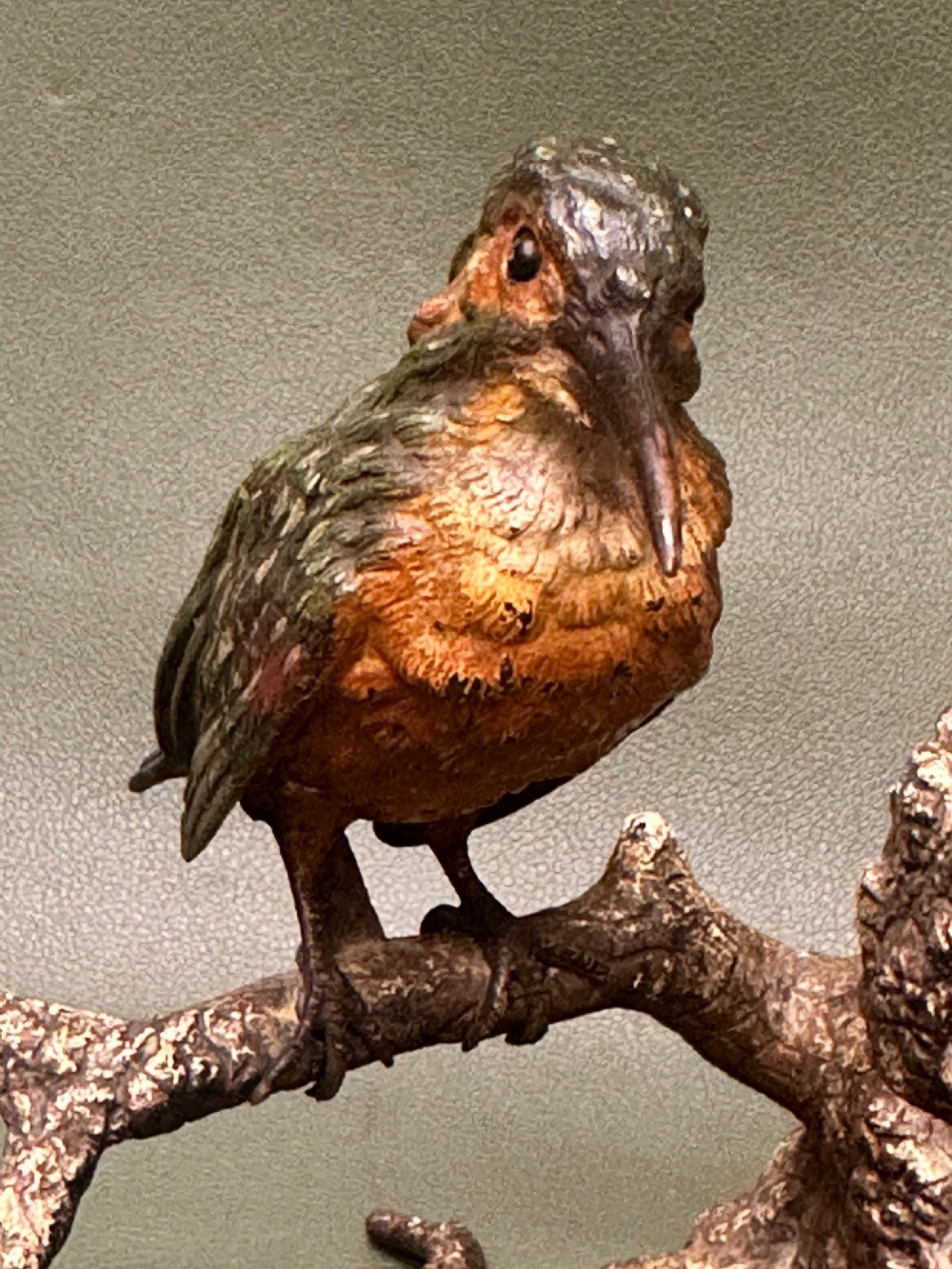 A cold painted bronze inkwell depicting a kingfisher bird perched on a branch above a tree stump base. View V