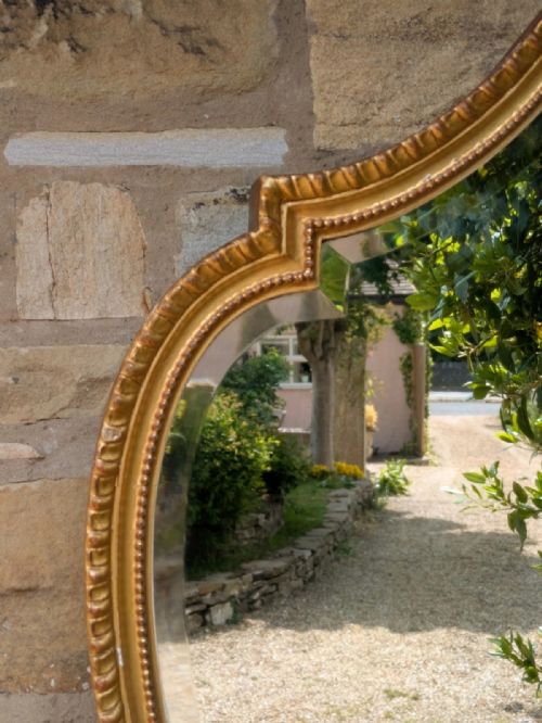 fig 1. A Gilt and Gesso Cartouche-Shaped Mirror, late 19th century