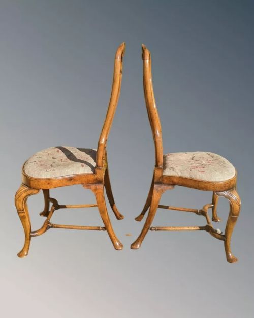 fig 2. A pair of Queen Anne walnut side chairs featuring splat backs, cabriole legs, and upholstered drop-in seats.