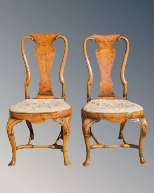 fig 3. A pair of Queen Anne walnut side chairs featuring splat backs, cabriole legs, and upholstered drop-in seats.