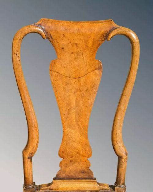 fig 4. A pair of Queen Anne walnut side chairs featuring splat backs, cabriole legs, and upholstered drop-in seats.