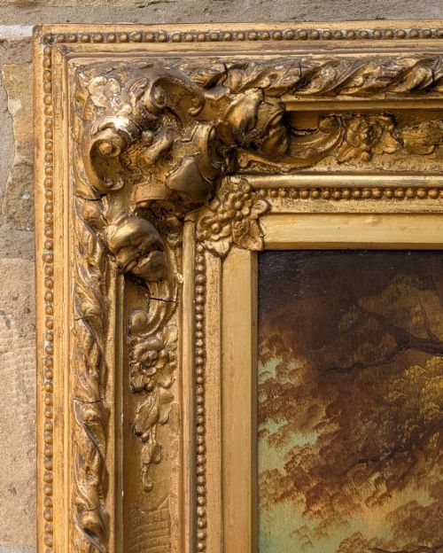 fig 2. An oil painting on canvas depicting a young girl feeding a goat outdoors, set within an ornate gilded frame.