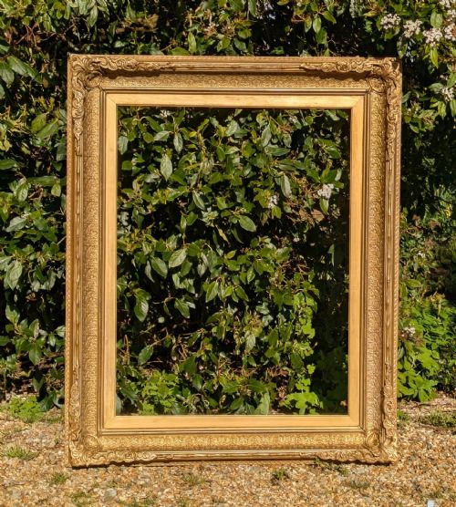 fig 1. A large rectangular Victorian picture frame with ornate gilt gesso moulding and intricate corner scrollwork.