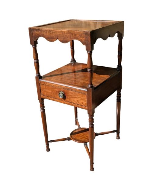 fig 1. A George III mahogany bedside table with an upper tray top, a middle shelf, a single drawer with a central brass handle, and turned legs joined by an X-stretcher with a small circular tier.